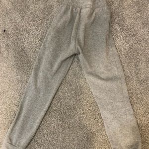 gray sweatpants, and purple horse print pajama pants